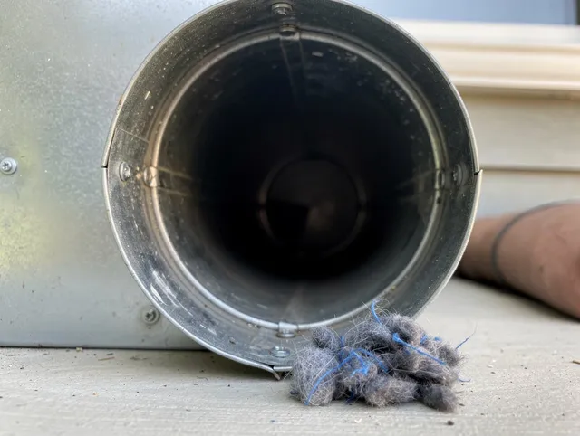 Lakeville Dryer Vent Cleaning technician using specialized equipment to clear severe dryer vent blockage in Lakeville
